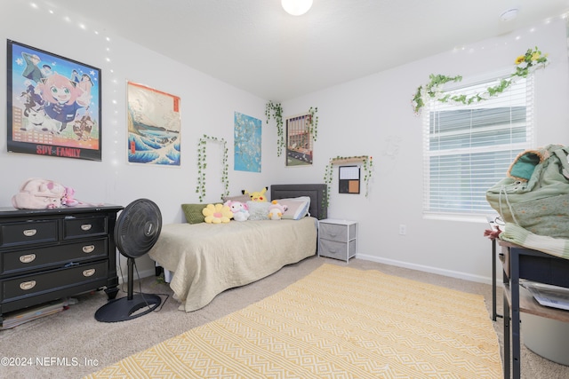 carpeted bedroom with multiple windows