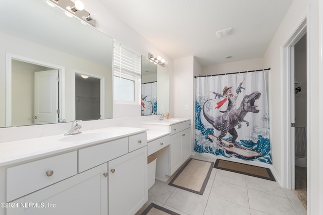 bathroom with tile patterned floors and vanity