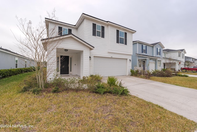 view of front of home featuring a garage and a front lawn