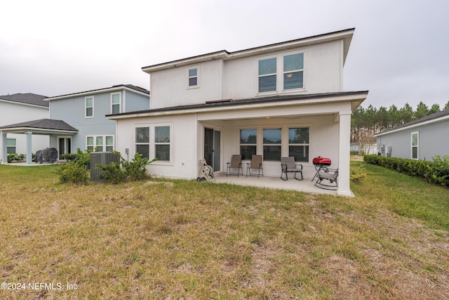 back of property with a yard and cooling unit