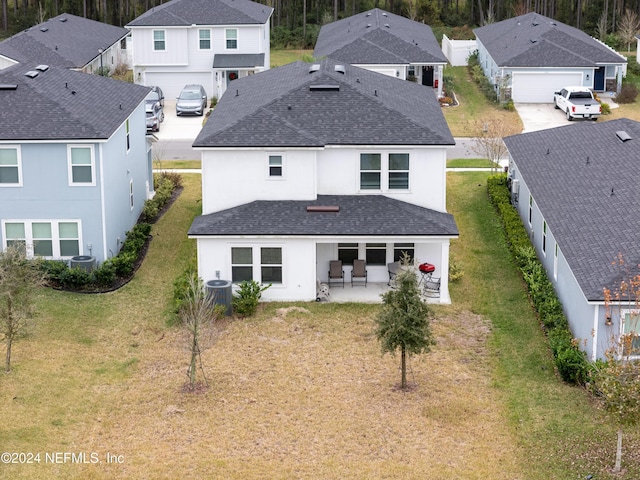 back of property featuring a patio and central AC