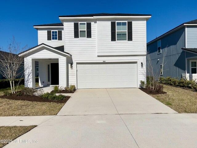 traditional-style home featuring concrete driveway and an attached garage