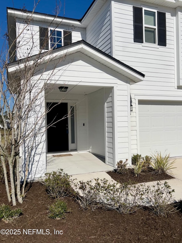 view of exterior entry featuring a garage