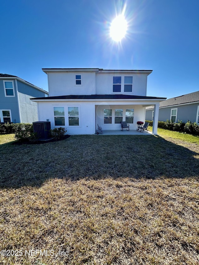 back of house with a lawn, a patio, and cooling unit