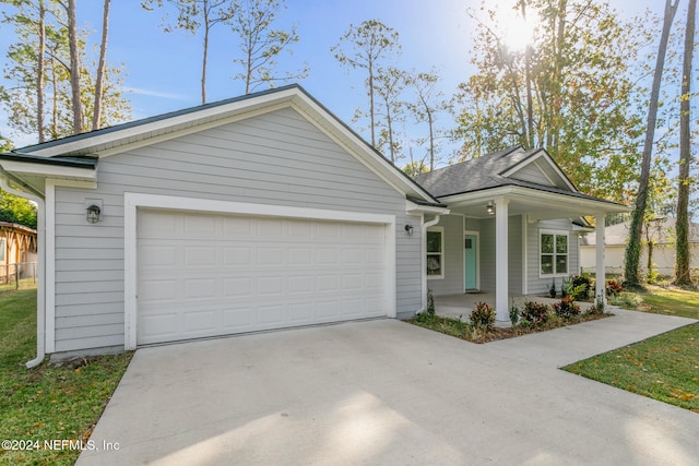 view of front of house with covered porch and a garage