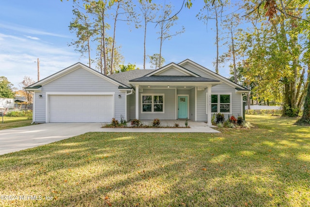 view of front of property with a front lawn, covered porch, and a garage