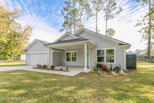 view of front of home with a front lawn, a porch, and a garage