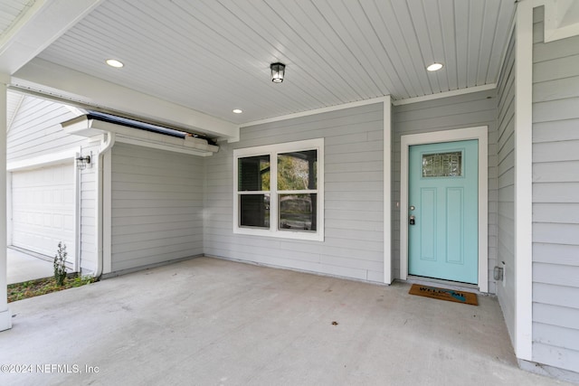 doorway to property with a garage