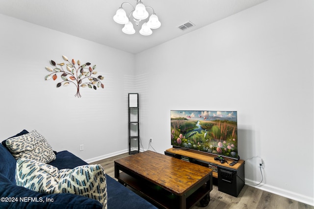 living room featuring hardwood / wood-style floors and an inviting chandelier