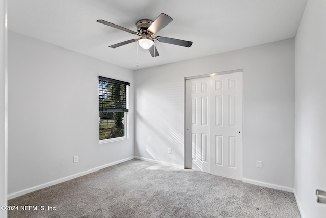 unfurnished bedroom with carpet, ceiling fan, and a closet