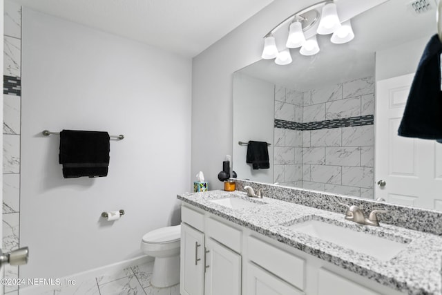 bathroom featuring vanity, toilet, and a tile shower