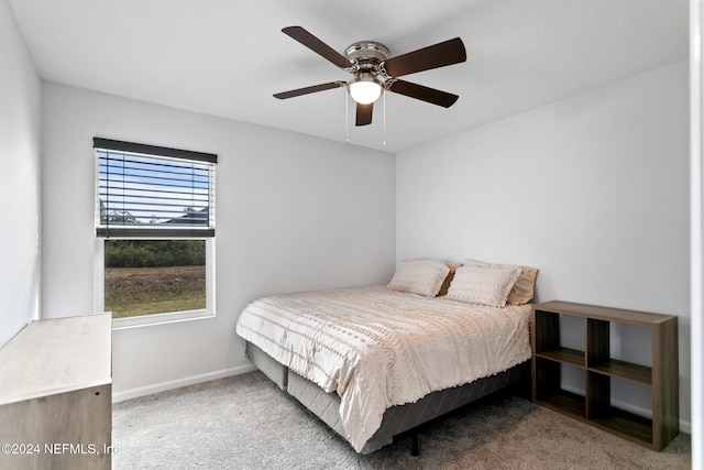 bedroom featuring carpet, multiple windows, and ceiling fan