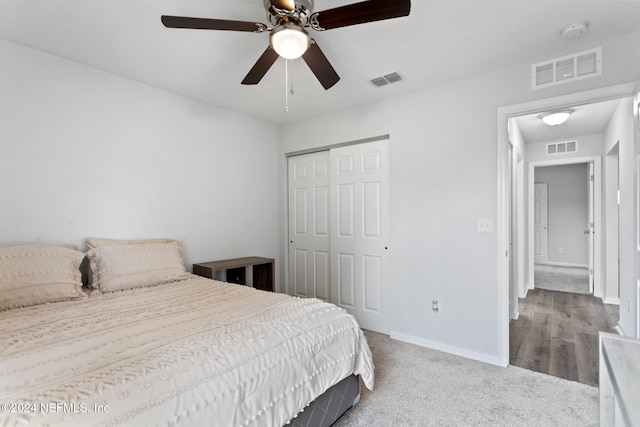 bedroom with hardwood / wood-style floors, a closet, and ceiling fan