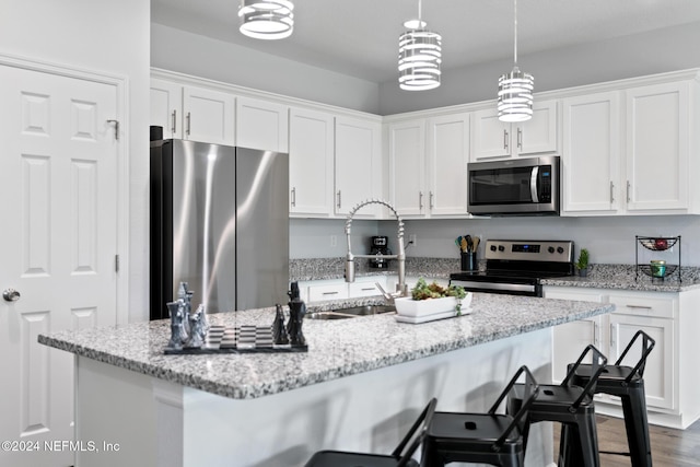 kitchen with white cabinets, sink, appliances with stainless steel finishes, and dark wood-type flooring