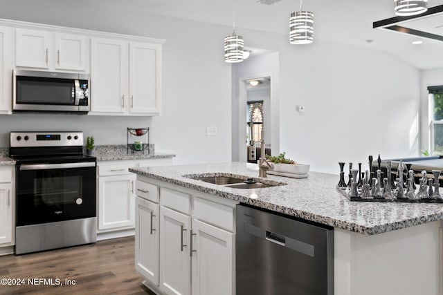 kitchen featuring light stone counters, stainless steel appliances, decorative light fixtures, white cabinets, and dark hardwood / wood-style floors