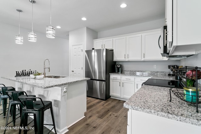 kitchen featuring stainless steel appliances, dark wood-type flooring, sink, decorative light fixtures, and white cabinets