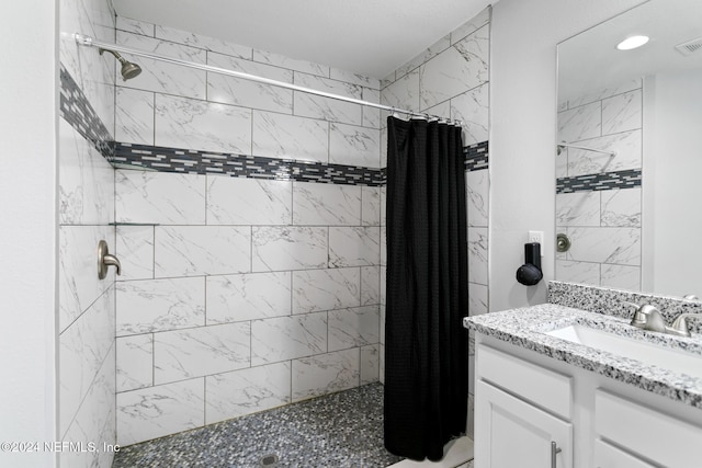 bathroom featuring vanity and walk in shower