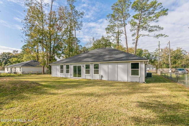 back of house featuring a yard and central air condition unit