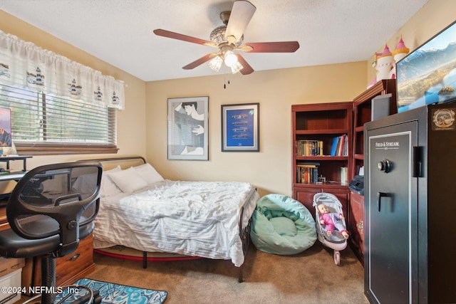 bedroom with a textured ceiling, ceiling fan, and carpet