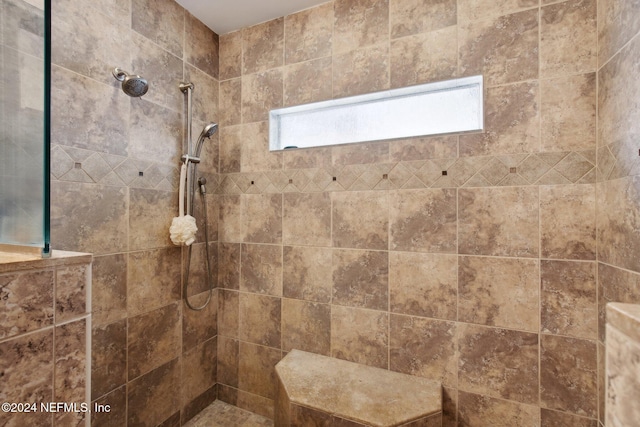 bathroom with a tile shower