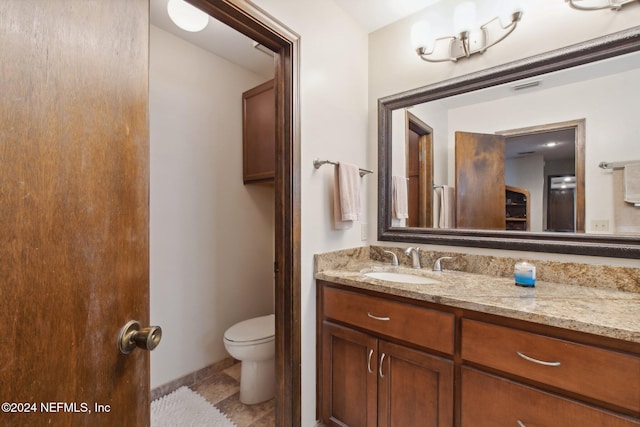 bathroom with toilet and vanity