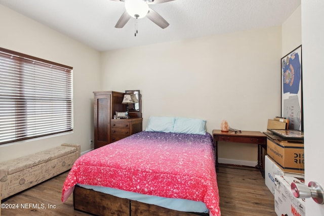 bedroom featuring ceiling fan and dark hardwood / wood-style flooring