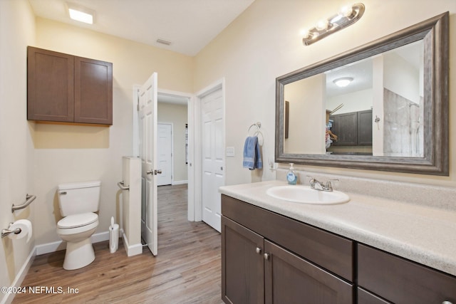 bathroom featuring hardwood / wood-style floors, vanity, and toilet