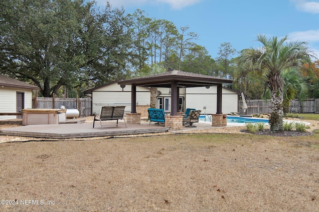 exterior space with a pool with hot tub, a patio, a lawn, and a gazebo