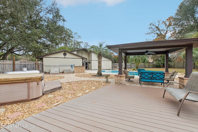 wooden deck with ceiling fan and a swimming pool with hot tub