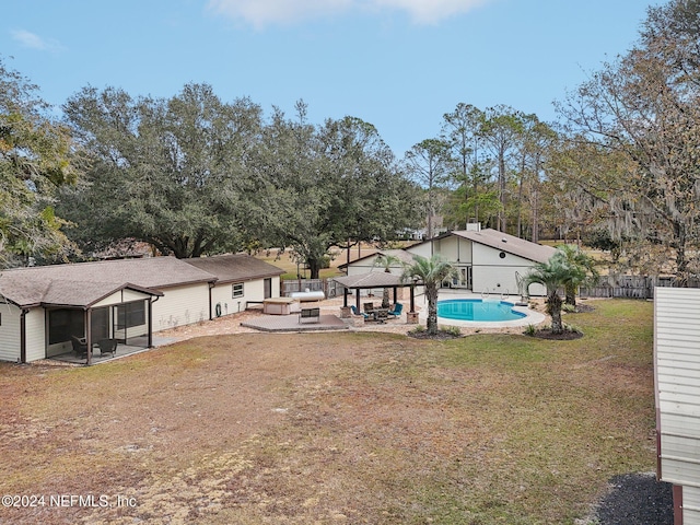 view of yard with a gazebo, a fenced in pool, a sunroom, and outdoor lounge area