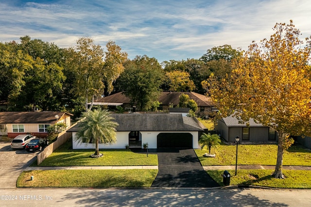 view of front of house with a front lawn and a garage