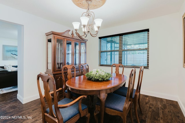 dining area featuring dark hardwood / wood-style floors, a wealth of natural light, and a chandelier