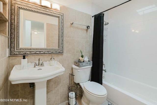 bathroom with toilet, tile walls, and shower / tub combo