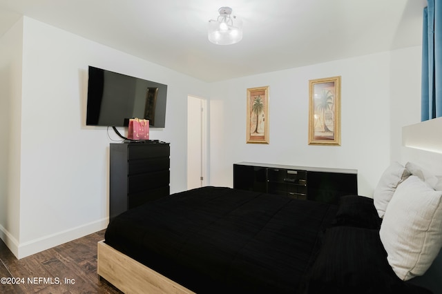 bedroom featuring dark wood-type flooring