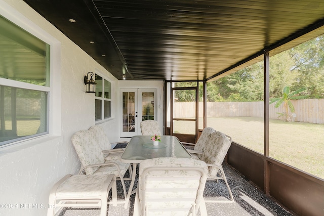 sunroom / solarium featuring french doors