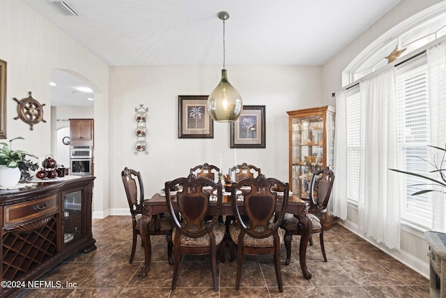 5321 Muskogean St, Saint Augustine, FL 32092 - dining space with arched walkways, healthy amount of natural light, and dark tile patterned flooring