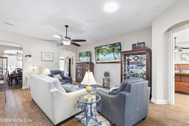 5321 Muskogean St, Saint Augustine, FL 32092 - living area featuring arched walkways, a ceiling fan, healthy amount of natural light, and light wood-style floors
