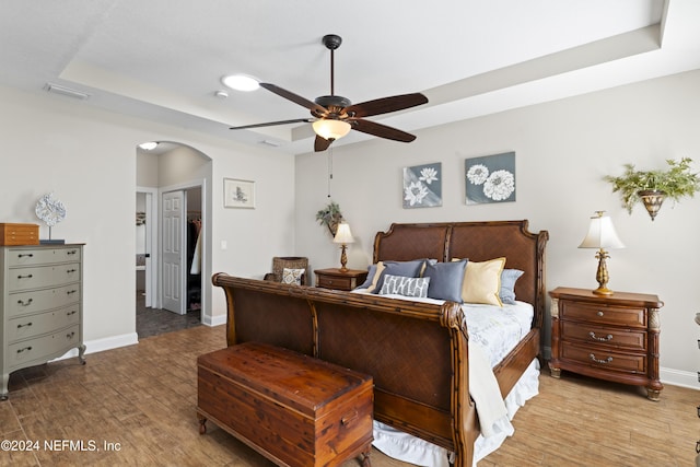 5321 Muskogean St, Saint Augustine, FL 32092 - bedroom with arched walkways, light wood finished floors, a tray ceiling, ceiling fan, and a closet