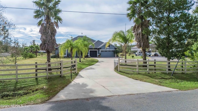 view of front of house with a front yard and a garage