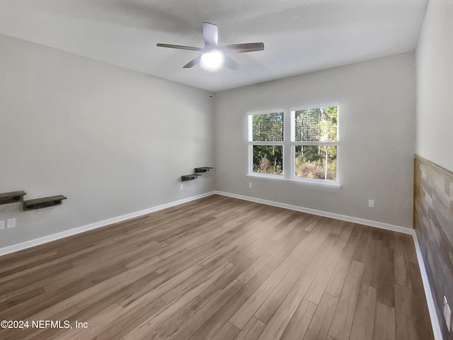 empty room featuring ceiling fan and hardwood / wood-style floors