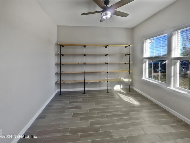 interior space with ceiling fan