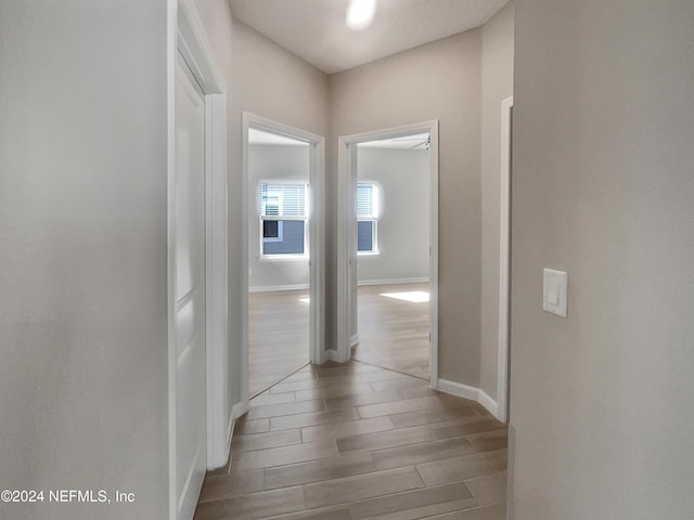 corridor with light hardwood / wood-style floors