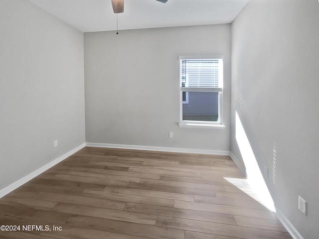 spare room with hardwood / wood-style floors and ceiling fan