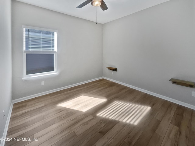 empty room with ceiling fan and hardwood / wood-style floors