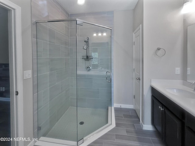 bathroom featuring vanity and an enclosed shower