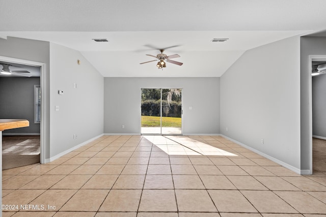 unfurnished room with ceiling fan, light tile patterned flooring, and vaulted ceiling