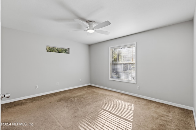 empty room with carpet flooring and ceiling fan