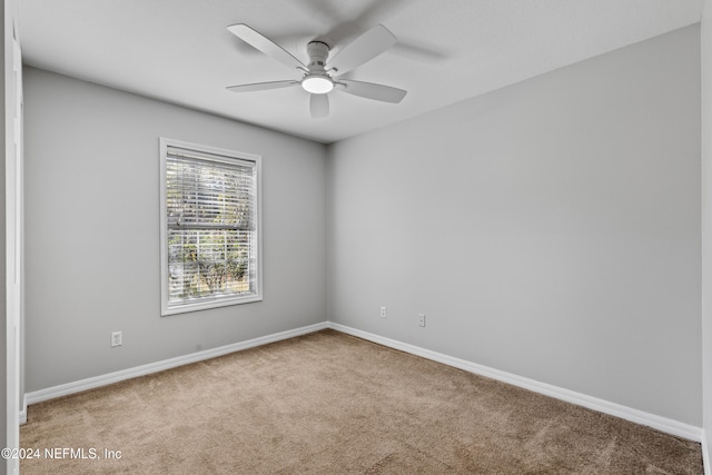 empty room featuring carpet flooring and ceiling fan