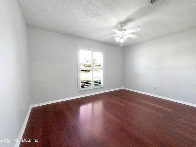 carpeted spare room with a textured ceiling and ceiling fan