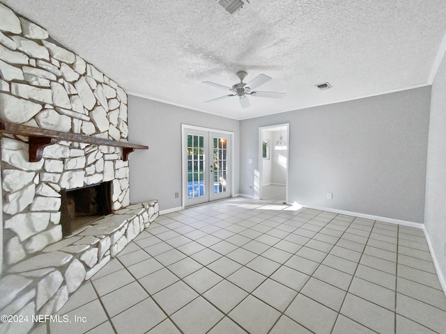 unfurnished living room featuring a fireplace, crown molding, french doors, and a textured ceiling